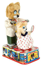 "BATTERY OPERATED WINKEY EYED BARBER BEAR" BOXED BATTERY TOY.