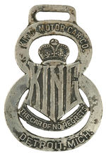 "KING THE CAR OF NO REGRETS" SILVERED BRASS FIGURAL WATCH FOB.