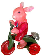 CELLO RABBIT ON TIN WIND-UP TRICYCLE.