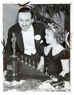 WALT DISNEY RECEIVES SPECIAL SNOW WHITE OSCAR FROM SHIRLEY TEMPLE PRESS PHOTO.