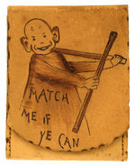 RARE LEATHER MATCH HOLDER WITH STRIKER PICTURING YELLOW KID HOLDING TWO GIANT MATCHES.