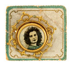 "GRETA GARBO" SUPERB PHOTO JEWELRY BADGE FROM THE LATE 1920s WITH CARD.