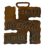 “DRINK COCA-COLA IN BOTTLES 5¢” BRASS WATCH FOB DESIGNED AS FIGURAL GOOD LUCK SWASTIKA SYMBOL.