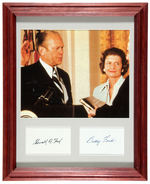 GERALD AND BETTY FORD FRAMED AUTOGRAPH WITH PHOTO OF HIM TAKING OATH OF OFFICE.