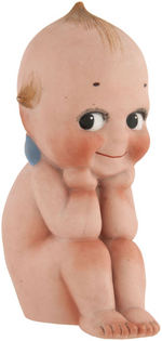 KEWPIE SEATED BISQUE FIGURE.