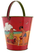 CHILDREN AT THE BEACH SAND PAIL.