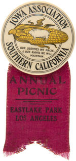 A HOG AND CORN EAR SYMBOLIZE "IOWA ASSOCIATION SOUTHERN CALIFORNIA" BUTTON WITH PICNIC RIBBON.