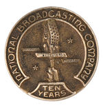 FOUR VERY EARLY RADIO INDUSTRY BADGES.