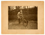 “LOVELL DIAMOND CYCLES” BICYCLE RACER PHOTO WITH DOG.