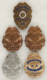 LOS ANGELES AIR PORT OFFICER BADGE PLUS FOUR AMERICAN AIRLINES SPECIAL POLICE BADGES.