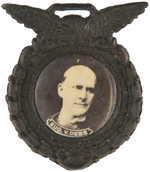 "EUG. V. DEBS" REAL PHOTO CELLO ON METAL WATCH FOB.