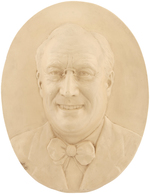 SMILING FDR HIGH RELIEF PORTRAIT ON OVAL PLASTER WALL PLAQUE AND PAIR OF PAPERWEIGHTS.