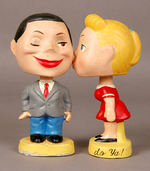 BRYLCREEM KISSING BOBBING HEAD COUPLE.