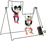 MICKEY MOUSE & DONALD DUCK CELLULOID TRAPEZE WIND-UP TOY.