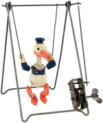 DONALD DUCK CELLULOID TRAPEZE WIND-UP TOY.