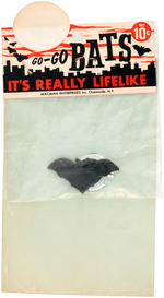 "OFFICIAL BAT RING" BAGGED NOVELTY WITH BATMAN PERSONAL APPEARANCE CANCELLATION CARD.