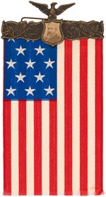 UNLISTED HARRISON PORTRAIT BRASS SHELL HANGER WITH MAGNIFICENT LARGE AMERICAN FLAG RIBBON.