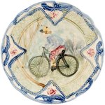 MAJOLICA PLATE WITH EARLY BICYCLIST IMAGE.
