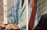 NASA ASTRONAUTS SIGNED PHOTO LOT WITH NASA ENVELOPE.