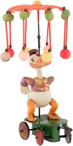 "DONALD DUCK CAROUSEL" BOXED CELLULOID WIND-UP TOY.