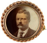 THEODORE ROOSEVELT 1904 FOUR SIMILARLY TINTED PINS, PENDANTS & STICKPIN.