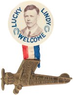 "LUCKY LINDY WELCOME" HORSESHOE MOTIF BUTTON WITH "SPIRIT OF ST. LOUIS" HANGER.