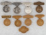 COLLECTION OF NINE WILLKIE NOTIFICATION DAY MEDALIC BADGES.