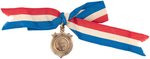 HARRISON & MORTON BACK TO BACK BRASS SHELL BADGE ON PATRIOTIC RIBBON.