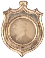 HARRISON & MORTON BACK TO BACK BRASS SHELL BADGE ON PATRIOTIC RIBBON.