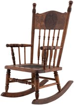 THE YELLOW KID OAK PRESS-BACK CHILD'S ROCKING CHAIR.