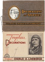 CHARLES LINDBERGH TROPHIES/DECORATIONS BOOK PAIR & SHEET MUSIC TRIO.