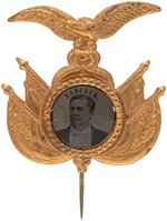 "HANCOCK" EAGLE AND FURLED FLAGS BRASS SHELL FERROTYPE BADGE.