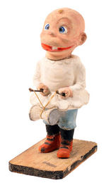 BABY SNOOKUMS COMPOSITION FIGURE HOLDING SPINNING TOY.