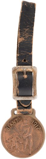 1912 NEW YORK GIANTS BRASS WATCH FOB W/LEATHER STRAP.