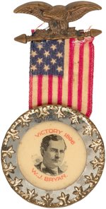"VICTORY 1896 W.J. BRYAN" FANCY RIBBON BADGE WITH FLAT CELLULOID IN SILVER FRAME.