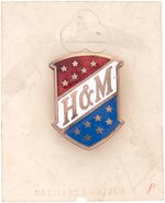 "HARRISON & MORTON" GRAPHIC ENAMEL ON BRASS BADGE WITH THEIR NAMES ON ORIGINAL CARD.