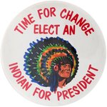 "TIME FOR A CHANGE/ ELECT AN INDIAN FOR PRESIDENT" HAND COLORED 1985 BUTTON.