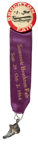 "BROCKTON FAIR" BUTTON SHOWING THREE EARLY AIRPLANES AND WITH 1914 RIBBON.