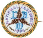 SUPERB "NATIONAL ASSEMBLY 1898 LAW" PORCELAIN ENAMEL IN BRASS FRAME BADGE BY O'HARA DIAL CO.