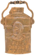 McKINLEY "FULL DINNER PAIL" FIGURAL BRASS SHELL BADGE.