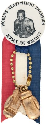 1951 JERSEY JOE WALCOTT "WORLD'S HEAVYWEIGHT CHAMPION" BUTTON WITH BOXING GLOVES ATTACHMENT.