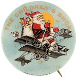 THE CHILDREN'S SHOP SANTA IN PUSHER TYPE BI-PLANE FLYING IN NIGHT SKY W/ YELLOW STARS  BUTTON.