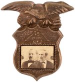 CLEVELAND & HENDRICKS CONJOINED JUGATE BRASS SHELL BADGE.