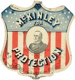 McKINLEY OUTSTANDING AMERICAN SHIELD TIN LITHO CAMPAIGN BADGE.