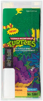 TEENAGE MUTANT NINJA TURTLES CAVE-TURTLE 2-PACK MIKE W/SILLY STEGOSAURUS AFA 80 NM.