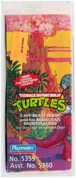 TEENAGE MUTANT NINJA TURTLES CAVE-TURTLE 2-PACK BEBOP W/BODACIOUS BRONTOSAURUS AFA 75 EX+/NM.