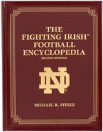 NOTRE DAME HEISMAN TROPHY WINNERS MULTI-SIGNED FOOTBALL & FIGHTING IRISH FOOTBALL ENCYCLOPEDIA.