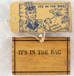 "IT'S IN THE BAG" WOOD BLOCK SUITCASE WITH UNCLE SAM ANTI HITLER AND ANTI HIDEKI TOJO MAILING TAG.