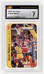 1986-87 FLEER STICKERS #9 AKEEM OLAJUWON (HOF) CSG 7 NM.