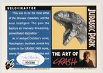 MICHAEL CRICHTON SIGNED JURASSIC PARK VELOCIRAPTOR CARD.